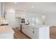 Open concept kitchen with white cabinetry, island, stainless steel appliances and view to the Gathering room at 44717 N 44Th Dr, Phoenix, AZ 85087