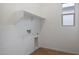 A simple laundry room with white walls, wood-look tile flooring, and a window at 44717 N 44Th Dr, Phoenix, AZ 85087