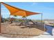 Community playground shaded by a large awning, offering slides and climbing structures for Gathering enjoyment at 44721 N 44Th Dr, Phoenix, AZ 85087