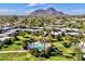 Aerial view showcases community pool with palm trees and Camelback mountain backdrop at 5682 N Scottsdale Rd, Paradise Valley, AZ 85253