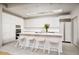 Modern kitchen featuring an island with seating, sleek white cabinetry, and stainless steel appliances at 5682 N Scottsdale Rd, Paradise Valley, AZ 85253