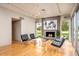 Bright living room featuring hardwood floors, fireplace, and large windows with views of the outdoor space at 5682 N Scottsdale Rd, Paradise Valley, AZ 85253