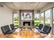 Sunlit living room featuring a fireplace and large windows with views of the outdoor space and mountains at 5682 N Scottsdale Rd, Paradise Valley, AZ 85253