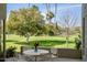 Beautiful patio with seating area and view of the lush lawn and palm trees at 5682 N Scottsdale Rd, Paradise Valley, AZ 85253