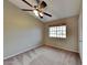 Bedroom with neutral walls, carpeted floor, window with blinds and a ceiling fan with lights at 625 S Westwood St # 108, Mesa, AZ 85210