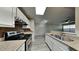 View of kitchen with granite countertops, white cabinets, stainless steel appliances and gray vinyl flooring at 625 S Westwood St # 108, Mesa, AZ 85210