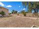 Spacious backyard with a mix of gravel and tile, offering potential for customization at 6915 E Gary Cir, Mesa, AZ 85207