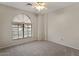 Comfortable bedroom featuring a ceiling fan and a large window for natural light at 6915 E Gary Cir, Mesa, AZ 85207