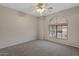 Bright bedroom with a ceiling fan and large window, offering plenty of natural light at 6915 E Gary Cir, Mesa, AZ 85207