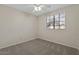 Cozy bedroom with neutral walls, carpet, a window with blinds and a white ceiling fan at 6915 E Gary Cir, Mesa, AZ 85207