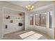 Cozy dining area featuring tile floors, built-in shelving, and large windows at 6915 E Gary Cir, Mesa, AZ 85207