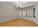 Dining room with hardwood floors, natural light, and stylish chandelier at 6915 E Gary Cir, Mesa, AZ 85207