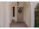 Charming front porch featuring a wreath, plants, and a welcome mat, creating a warm and inviting entryway at 6915 E Gary Cir, Mesa, AZ 85207