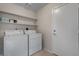 Cozy laundry room features a washer, dryer and storage shelves at 6915 E Gary Cir, Mesa, AZ 85207