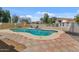 Inviting in-ground pool with an umbrella table set and tiled patio area at 6915 E Gary Cir, Mesa, AZ 85207