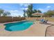 Backyard pool featuring lounge chairs, an umbrella, a patio, and a surrounding fence at 6915 E Gary Cir, Mesa, AZ 85207