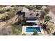 Backyard aerial of a home featuring pool, covered patio, desert landscaping, and grassy area at 7100 E Montgomery Rd, Scottsdale, AZ 85266