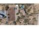 Desert home with horse arena, pool, covered parking, desert landscape, and outbuildings from above at 7100 E Montgomery Rd, Scottsdale, AZ 85266
