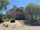 Beautiful backyard with a patio balcony, mature trees, and desert foliage at 7100 E Montgomery Rd, Scottsdale, AZ 85266