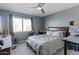 Bedroom with gray walls, carpeted floor, ceiling fan and a window with natural light at 7100 E Montgomery Rd, Scottsdale, AZ 85266