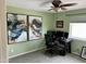 Bright bedroom with a ceiling fan, gray carpet, modern decor, and a large window for natural light at 7100 E Montgomery Rd, Scottsdale, AZ 85266