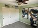 Bedroom features gray carpet, ceiling fan, closet with sliding doors, and unique modern wall art at 7100 E Montgomery Rd, Scottsdale, AZ 85266