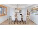 Dining room with a contemporary light fixture, a wooden table, and comfortable seating at 7100 E Montgomery Rd, Scottsdale, AZ 85266