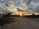 Desert property with sunset and dirt road at 7100 E Montgomery Rd, Scottsdale, AZ 85266