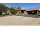 Exterior shot of home with gravel landscaping, a covered parking area, and desert vegetation at 7100 E Montgomery Rd, Scottsdale, AZ 85266