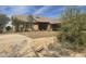 Charming single story home showcasing a desert landscaped front yard and double-door entry at 7100 E Montgomery Rd, Scottsdale, AZ 85266
