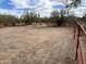 View of a fenced horse paddock with desert landscaping and clear blue sky at 7100 E Montgomery Rd, Scottsdale, AZ 85266