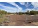 View of a fenced horse paddock with desert landscaping and clear blue sky at 7100 E Montgomery Rd, Scottsdale, AZ 85266