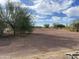 View of a horse paddock with desert landscaping and clear blue sky at 7100 E Montgomery Rd, Scottsdale, AZ 85266