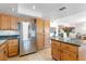 Kitchen island with wood cabinets, granite countertops, and stainless steel appliances at 7100 E Montgomery Rd, Scottsdale, AZ 85266