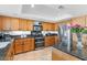 Spacious kitchen with stainless steel appliances, wooden cabinets, and granite countertops at 7100 E Montgomery Rd, Scottsdale, AZ 85266