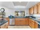 Kitchen featuring stainless steel appliances, granite countertops, tile flooring, and large window at 7100 E Montgomery Rd, Scottsdale, AZ 85266