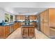 Kitchen featuring stainless steel appliances, granite countertops, kitchen island, and tile flooring at 7100 E Montgomery Rd, Scottsdale, AZ 85266