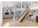 Bright living room featuring high ceilings, a modern staircase, and an open floor plan at 7100 E Montgomery Rd, Scottsdale, AZ 85266