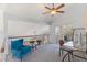 Comfortable loft space with carpeted floor, a ceiling fan, and a sliding glass door to a balcony at 7100 E Montgomery Rd, Scottsdale, AZ 85266