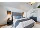 Beautifully decorated main bedroom with a gray tufted headboard, bedside tables, and stylish artwork at 7100 E Montgomery Rd, Scottsdale, AZ 85266