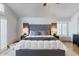 Comfortable main bedroom featuring a gray tufted headboard, plush bedding, and bright natural light at 7100 E Montgomery Rd, Scottsdale, AZ 85266