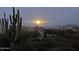 Beautiful view of a night sky, the moon and a Saguaro Cactus in the foreground at 7100 E Montgomery Rd, Scottsdale, AZ 85266