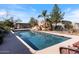 Stunning backyard pool with rock features and lush landscaping at 7100 E Montgomery Rd, Scottsdale, AZ 85266