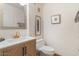 Stylish powder room with a modern vanity, marble countertop, and elegant fixtures at 7100 E Montgomery Rd, Scottsdale, AZ 85266