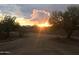 Picturesque view of a stunning desert sunset illuminating the property and surrounding landscape at 7100 E Montgomery Rd, Scottsdale, AZ 85266