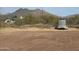 Scenic view of home with desert landscape and mountain backdrop, next to a utility trailer at 7100 E Montgomery Rd, Scottsdale, AZ 85266