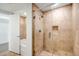 A bathroom featuring a walk-in shower with glass doors and neutral tile at 7121 E Rancho Vista Dr # 5011, Scottsdale, AZ 85251