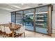 Bright dining area featuring a wooden table and patio doors that offer views of the community courtyard at 7121 E Rancho Vista Dr # 5011, Scottsdale, AZ 85251