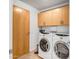 Well-equipped laundry room with upper cabinets and modern washer and dryer units at 7121 E Rancho Vista Dr # 5011, Scottsdale, AZ 85251