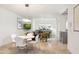 Well lit dining room with white table and chairs adjacent to the kitchen and living room at 7126 N Via Nueva --, Scottsdale, AZ 85258